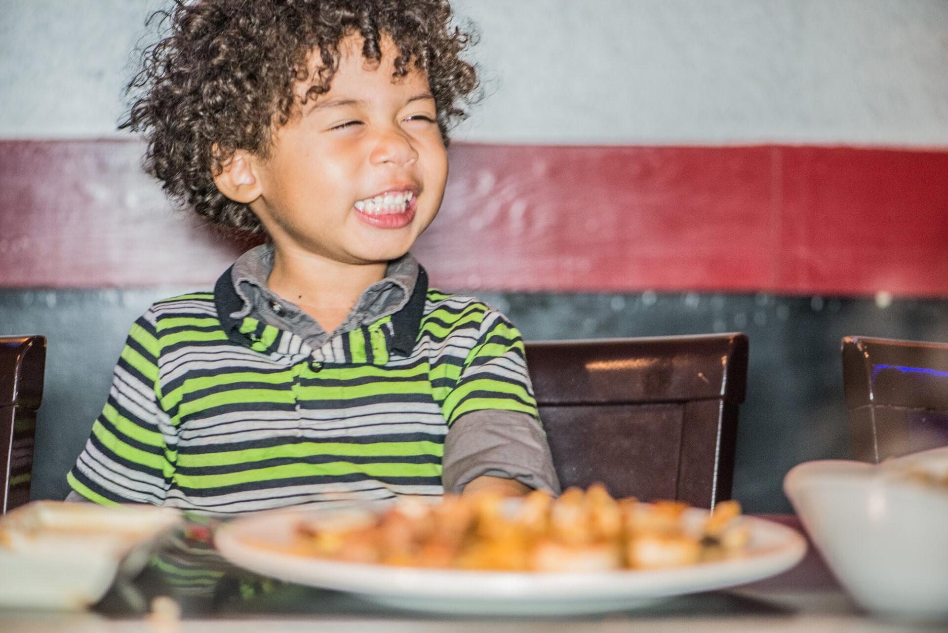 Young child smiling in a Kobe restaurant