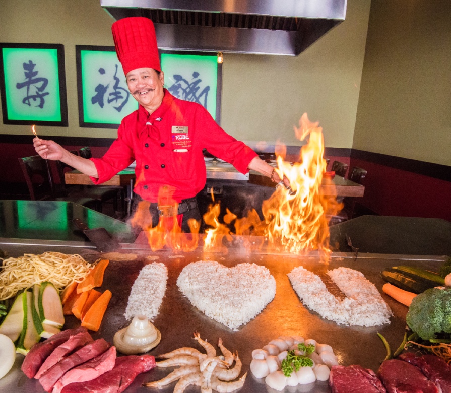 Teppanyaki Chef with flame and I Love You written in rice on grill.
