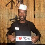 Kobe employee holding I Love Kobe sign