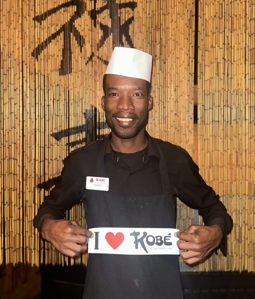 Kobe employee holding I Love Kobe sign