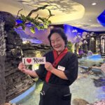 Kobe Employee holding I Love Kobe Sign